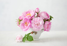 Small Light Pink Bouquet Of Roses In Porcelain Vase Against Of Pale Grey Background.  Shallow Depth Of Field. Selective Focus.