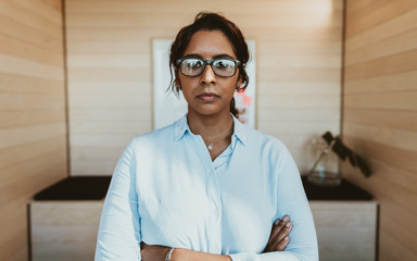 Wall Mural - Confident young businesswoman standing in office