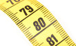 © michaklootwijk - Close-up of a yellow measuring tape isolated on white - 80