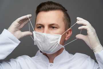 Wall Mural - Doctor wearing hygienic mask to prevent infection