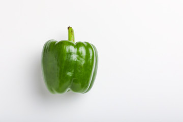 Wall Mural - fresh green bell pepper (capsicum) on a white background