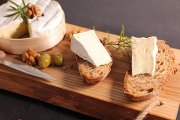 Poster - bread slice with camembert on wooden board