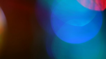 Poster - multi-colored spinning glare on a black background