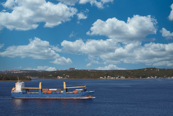 Wall Mural - Freighter sailing through calm blue waters off the coast of Halifax