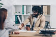 © LIGHTFIELD STUDIOS - African american recruiter shaking hands with employee at job interview in office