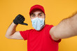 © ViDi Studio - Close up delivery man in red cap blank t-shirt uniform sterile face mask gloves isolated on yellow background studio Guy employee doing selfie shot Service pandemic coronavirus virus 2019-ncov concept