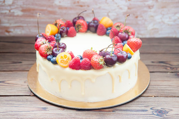 Wall Mural - Cheesecake with white chocolate, fresh berries, strawberries, cherries, blueberries and raspberries on wooden background