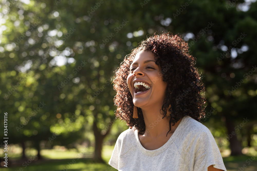 Laughing young woman enjoying a sunny day in the park Stock Photo ...