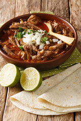 Wall Mural - Birria is a Mexican dish is a spicy stew, traditionally made from goat meat closeup in a bowl. Vertical
