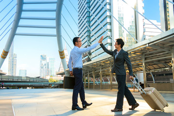 Two young businessmen greet for business negotiations with city