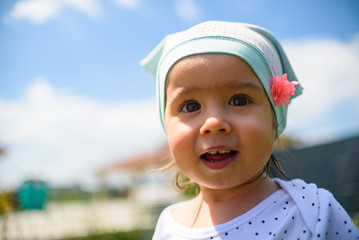 Portrait of very sweet little child with big eyes. 1 year old baby girl