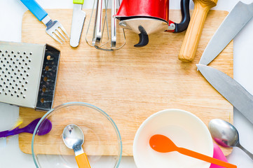 Kitchen utensils. Kitchen ware. Kitchen flat lay. Part of coffe-maker, knife, spoon, fork, mixer, grater, plunder and wooden cutting board