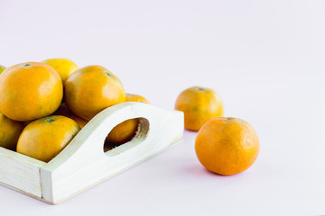 Orange in the wooden box on pink background for fruit and eating concept