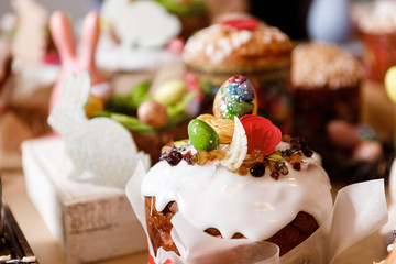 Wall Mural - Easter cake orthodox sweet bread kulich and colorful chocolate eggs on festive table