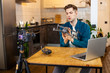 © alfa27 - handsome caucasian man blogger talk about modern devices and technologies, sit in front of camera and present his purchase, new device. blogging, broadcast concept
