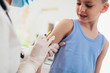 © Mediteraneo - Pediatrician makes vaccination to small boy. Female doctor vaccinating little boy.