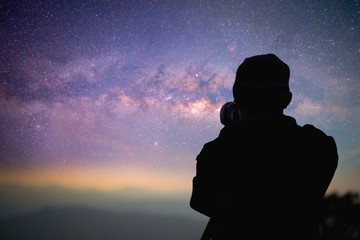 Wall Mural - photographer or traveller using a professional dslr camera take photo beautiful landscape of milky w