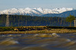 Fast River with snow covered mountains in back ground, forest, Kashmir India