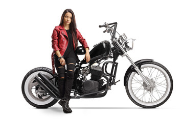 Wall Mural - Female biker holding a helmet and sitting on a chopper