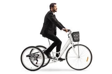 Canvas Print - Businessman riding a tricycle