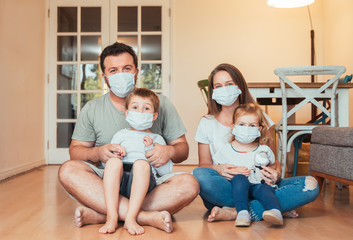 Happy and beautiful young family at home quarantine due to Corona Virus pandemic