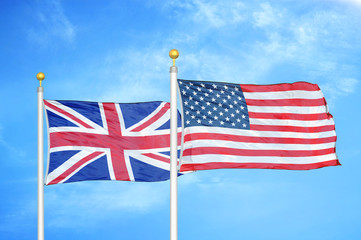 Canvas Print - United Kingdom and United States two flags on flagpoles and blue cloudy sky