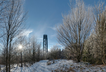 Wall Mural - Winter countryside with snow and trees and Tesak observation tower, Czech Republic