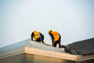 Poster - Engineer wear safety uniform inspection installing new roof of modern house.