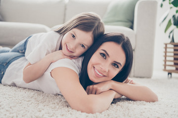 Sticker - Closeup photo of pretty funny little girl young mommy lying fluffy comfy carpet toothy smiling spend free time weekend together homey mood casual clothing home indoors