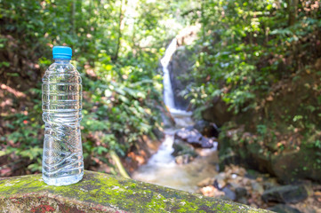 mineral bottle with blurred green natural background