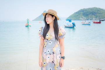 Portrait young beautiful asian woman walk smile and happy on the beach sea and ocean for leisure travel in holiday vacation 