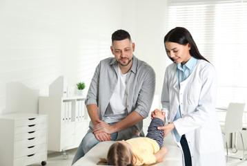 Sticker - Professional orthopedist examining little patient's leg in clinic