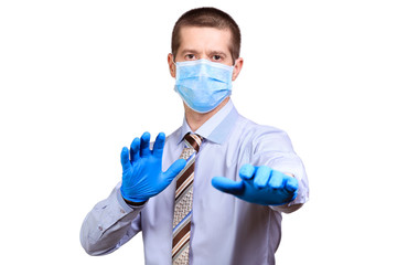 Wall Mural - Terrified man in medical mask, shirt, tie, rubber gloves shows gesture not to approach