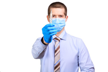 Wall Mural - Man wearing rubber gloves, medical mask on his face, shows on a degree bar isolated