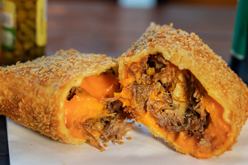 Wall Mural - pastel frito da culinária brasileira de massa crispy com recheio de costela com cheddar encima de gu