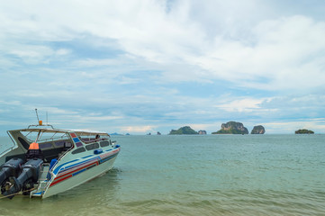 Wall Mural - Traveler boat at beach with blue skies