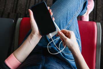 Woman hands with smartphone and power bank