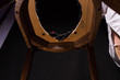 Chair with a hole for bowel movements and perversions. On a black background
