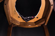 Chair with a hole for bowel movements and perversions. On a black background