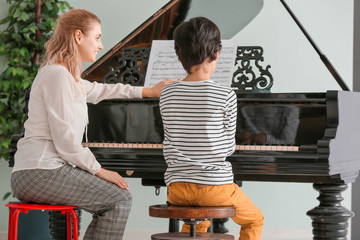 Sticker - Private music teacher giving piano lessons to little boy