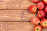 Fototapeta Mapy - many red apples on a wooden table