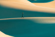 © Charly Savely - Woman walking on sand dunes