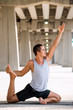 © Luna Vandoorne - Mexican man practicing yoga in a urban background