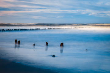 Wall Mural - Long exposure shot of the sea and a pier in a sunset, Baltic Sea, Poland