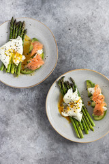 Wall Mural - Green asparagus with poached egg, avocado , creme cheese and salmon on a plate