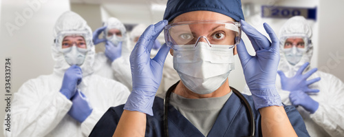 Fotomural Team of Female and Male Doctors or Nurses Wearing Personal Protective Equiment I