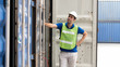© Mongkolchon - industrail background of caucasian containers yard and cargo inspector working at containers loading area