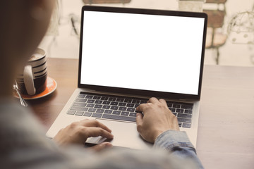 mockup image blank screen computer with white background for advertising text,hand woman using laptop contact business search information on desk at coffee shop.marketing and creative design