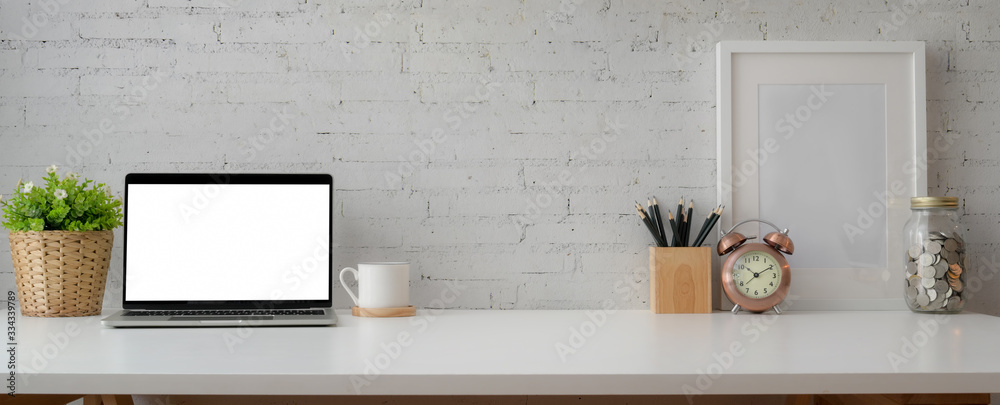 Cropped shot of simple workspace with mock-up laptop, stationery, decorations and copy space - obrazy, fototapety, plakaty 
