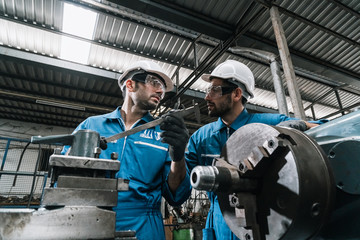 Wall Mural - Engineer men wearing uniform safety in factory working machine lathe metal.